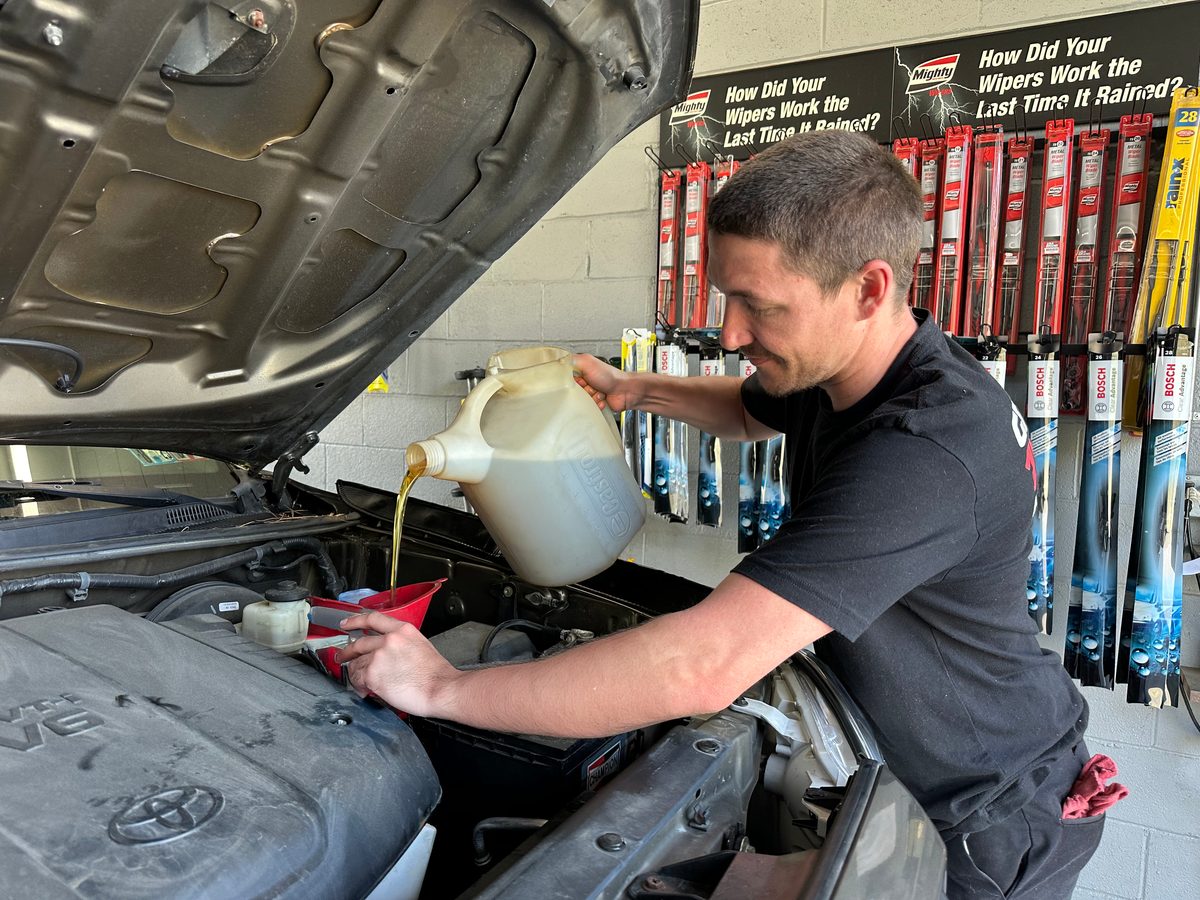 Pennzoil motor oil being poured into a vehicle at Great Bear